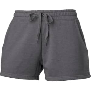 A pair of grey women's sweatshorts featuring an elastic waistband and pockets. It has a logo on the fabric.