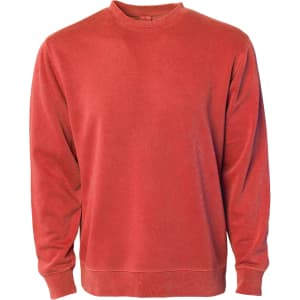 A unisex crew sweatshirt in a vibrant terracotta colour with a classic crew neck and long sleeves. It features a brand logo.
