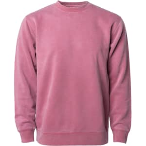A unisex crew sweatshirt in a pigment-dyed rose colour with long sleeves and a round neckline. It has a logo.