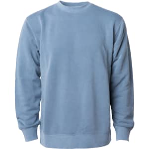 A unisex crew sweatshirt in a soft blue pigment dye, featuring long sleeves and a round neckline.