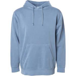 A unisex pullover hoodie in a soft blue pigment dye, featuring a front pocket and a hood. It has a logo.