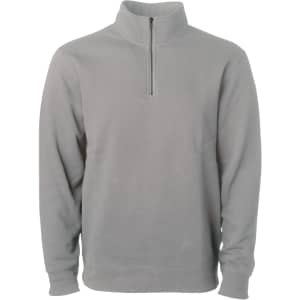 A unisex pigment dye quarter zip in grey, featuring long sleeves and a front zip. It has a logo on it.