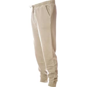 A pair of men's pigment dye sweatpants in beige with an elastic waistband and side pockets.