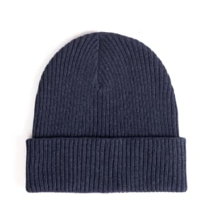 A ribbed beanie in navy blue featuring a folded cuff and a textured design. It has a logo on the side.