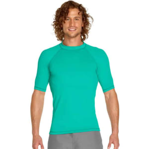 A short sleeve rashie in teal with a snug fit and stretch fabric, featuring a logo on the chest.