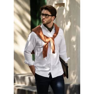 A slim fit white button-up shirt is worn by a man with brown accents, styled with a brown sweater draped around his shoulders.