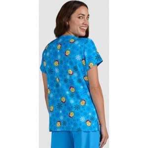 A blue top featuring a playful pattern of smiling faces and snowflakes. The back view displays a vibrant design.