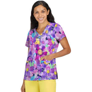 A vibrant purple scrub top featuring cheerful smiley faces and pockets, worn by a smiling woman.
