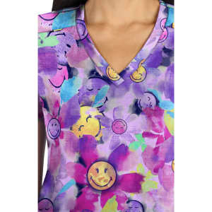 A V-neck top featuring a vibrant purple and floral pattern with smiling face motifs throughout.