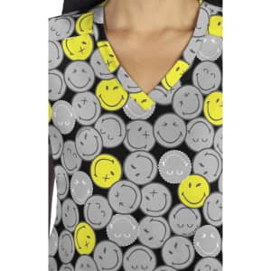 A patterned top featuring grey and yellow smiley faces on a black background with a V-neck design.