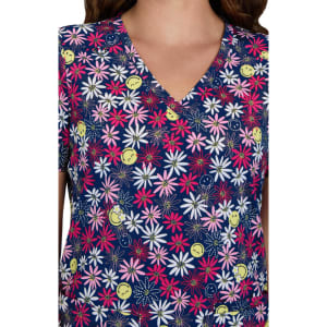 A floral print scrub top featuring navy blue, pink, yellow, and white colours with a V-neck design.