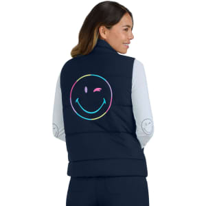 A navy vest featuring a large, colourful smiley face on the back, worn by a woman with long hair.