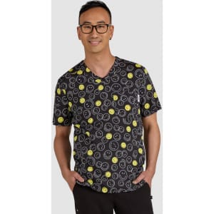 A black top featuring a playful pattern of yellow smiley faces, worn by a man with glasses. The product has a logo.