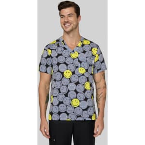 A printed grey top featuring a pattern of smiling yellow and grey faces, worn by a man. The top has a logo.