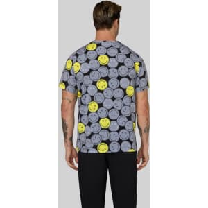 A patterned T-shirt featuring grey smiley faces and bright yellow accents, with a plain grey background.