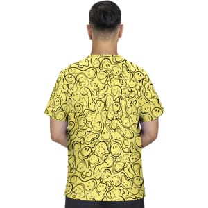 A yellow T-shirt featuring a playful pattern of smiling faces, displayed from the back. It has a logo on the front.