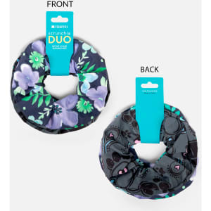 A printed scrunchie duo set featuring floral designs in navy and grey, with a branding tag attached.