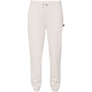 Cream-coloured sweatpants with an elastic waistband and cuffs, featuring a small logo on the side.