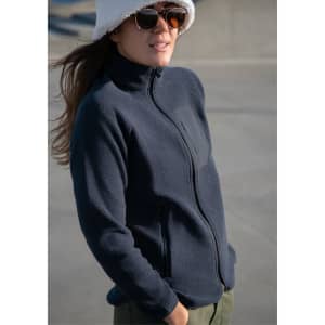 A navy women's jacket with a zip front, featuring a sleek design and side pockets, worn by a model.