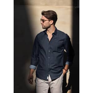 A modern fit men's button-up shirt in navy, featuring a collar and rolled sleeves, displayed on a model.