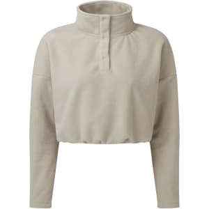 A cropped fleece top in a light beige colour with a high collar and button detailing. It features long sleeves and a relaxed fit.