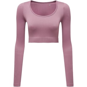 A ribbed seamless crop top in light pink with long sleeves and a round neckline, featuring a logo.