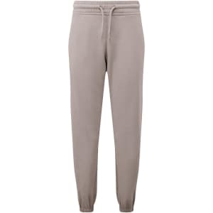 A pair of unisex recycled joggers in a beige colour with a drawstring waistband and elastic cuffs.