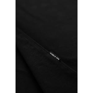 A black T-shirt displaying a tag featuring a logo. The fabric appears soft and fold is visible.