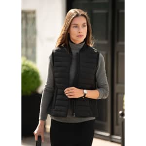 A black women's vest with a quilted design, worn over a grey turtleneck, set against a stylish background.