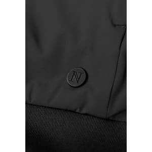 A black hybrid jacket featuring a textured fabric and a small branding logo on the surface.