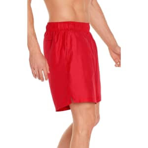 A pair of red men's swim trunks designed for sun protection, featuring an elastic waistband and side pocket.