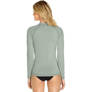 A long sleeve rashie in a muted green colour, featuring a logo on the back.