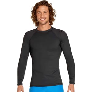 A man wearing a black long sleeve rashie with a fitted design and a logo on the chest.