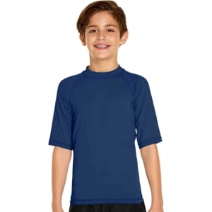 A young boy is wearing a navy blue short sleeve rashie designed for sun protection with a logo on it.