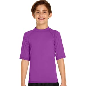 A purple youth short sleeve rashie with a fitted design and a high collar, featuring a logo on the chest.
