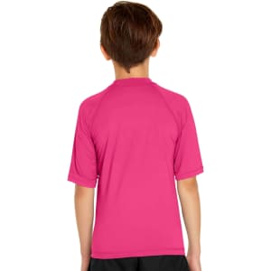 A youth short sleeve rashie in vibrant pink with a logo on the back. Suitable for sun protection with UPF 50+.