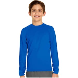 A boy wearing a long sleeve rashie in bright blue, featuring a logo on the garment.