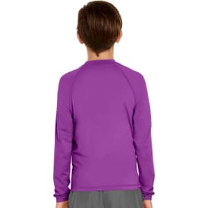 A youth long sleeve rashie in purple with a plain design at the back. It has a logo on the upper section.