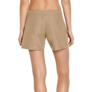 Women's cargo board shorts in a light tan colour, featuring a waistband and side pocket. Contains branding.