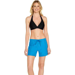 A woman stands wearing bright blue cargo board shorts paired with a black bikini top. The shorts have a drawstring.