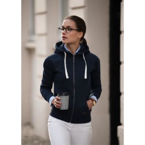 A navy hoodie jacket with a zip and drawstring hood, worn by a woman holding a coffee cup.