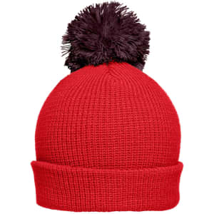 A bright red beanie hat with a black pompon on top, featuring a ribbed texture. It has a fold-over brim and a logo.