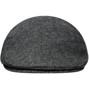 A grey herringbone cap with a rounded peak and a flat top, featuring a subtle texture and a branding logo.
