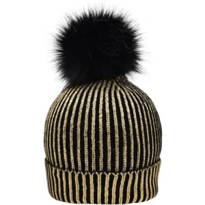 A black and gold metallic beanie featuring a fluffy black pom-pom on top and a ribbed design.