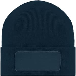A knitted beanie in dark blue featuring a blank patch for custom branding.