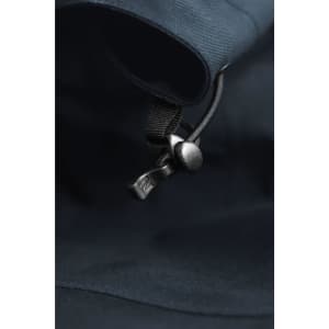 A close-up of a dark navy shell jacket featuring a zip and adjustable toggle. The fabric appears smooth and lightweight.