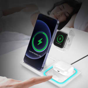 A white 3-in-1 wireless charger for a phone, smartwatch, and earbuds, featuring a green charging indicator.
