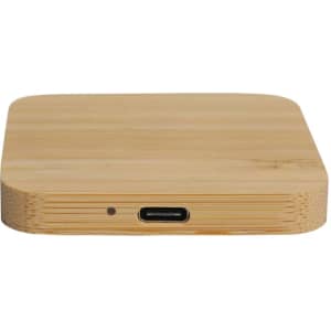 A rectangular bamboo wireless charger with a USB-C port on the side. The surface is smooth and natural in colour.
