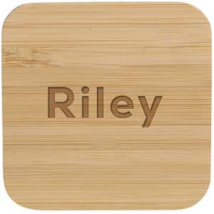A bamboo wireless charger with a smooth, natural finish and rounded edges. It features a logo on the surface.