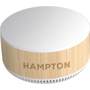 A round, wooden-textured wireless charging speaker in cream and light beige, featuring a brand logo.